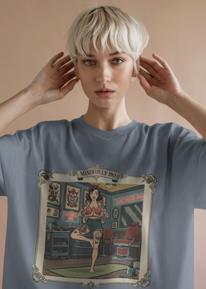 Person wearing a blue t-shirt with a graphic design on a beige background