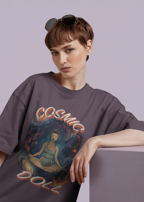 Person wearing a gray t-shirt with a graphic design on a plain background