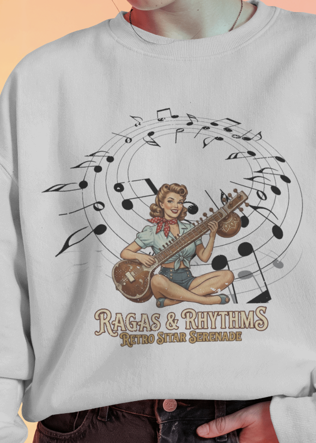 Gray sweatshirt with a graphic design of a woman playing a sitar and musical notes, with text 'Ragas & Rhythms'.