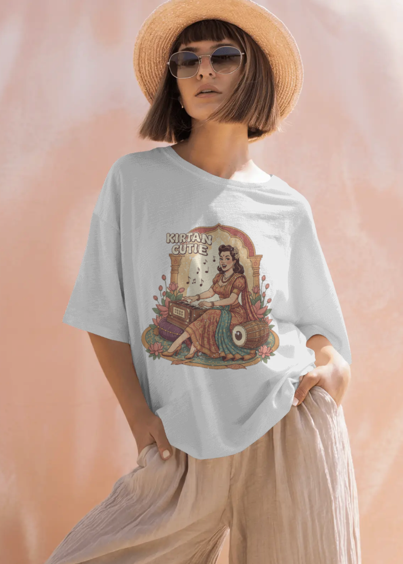 Woman wearing a white t-shirt with a graphic design on a peach background