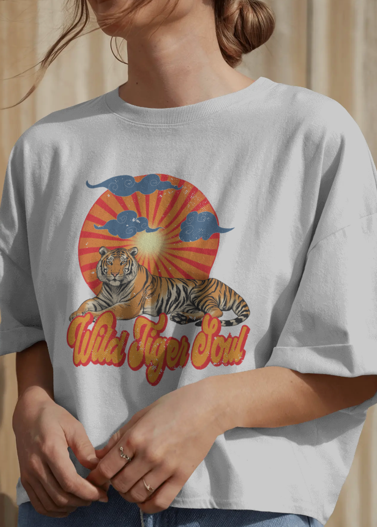 Person wearing a white t-shirt with a tiger graphic and 'Wild Tiger Girl' text.
