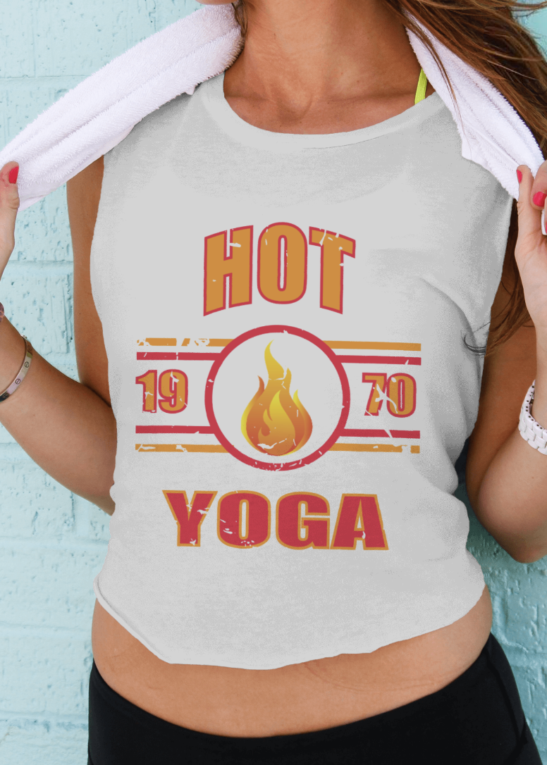 Person wearing a tank top with 'Hot Yoga' text and design against a light blue brick wall.