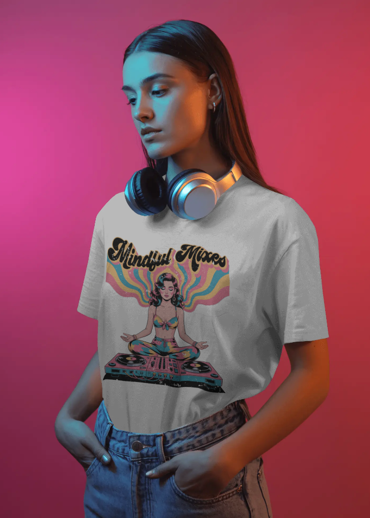 Person wearing a t-shirt with 'Mindful Mixes' design and headphones on a pink and red gradient background