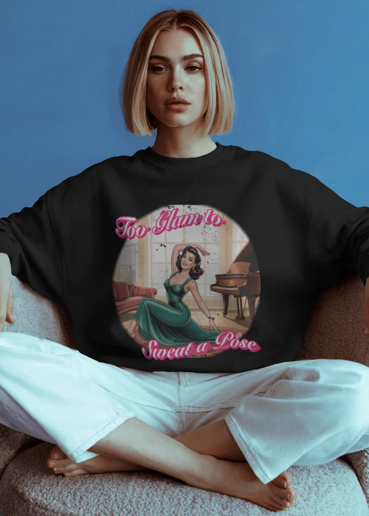 Person wearing a black sweatshirt with a graphic design sitting on a chair against a blue background