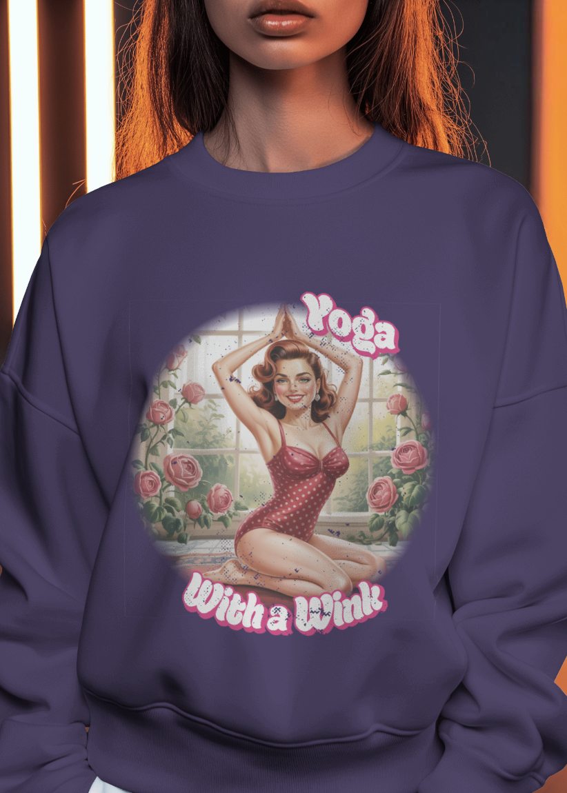 Purple sweatshirt with a graphic design of a woman in a red dress and 'Yoga with a Wink' text.