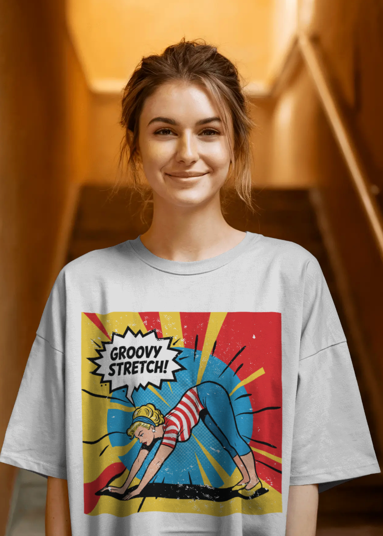 Person wearing a t-shirt with a graphic design of a person stretching and the text 'Groovy Stretch!'.
