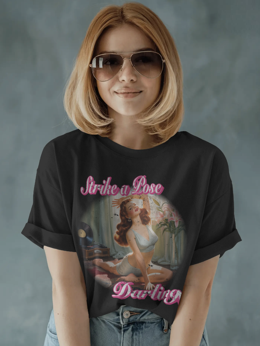 Woman wearing black Strike a Pose Darling vintage pin-up graphic t-shirt with sunglasses